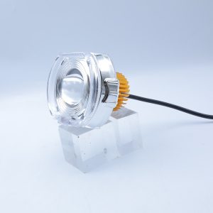 Large option angled view showing housing depth, projector lens, rear heat sink, and wire lead.